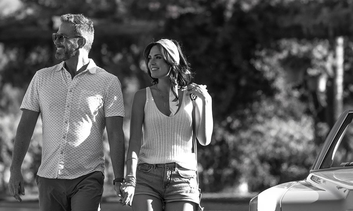 couple holding hands on arrival